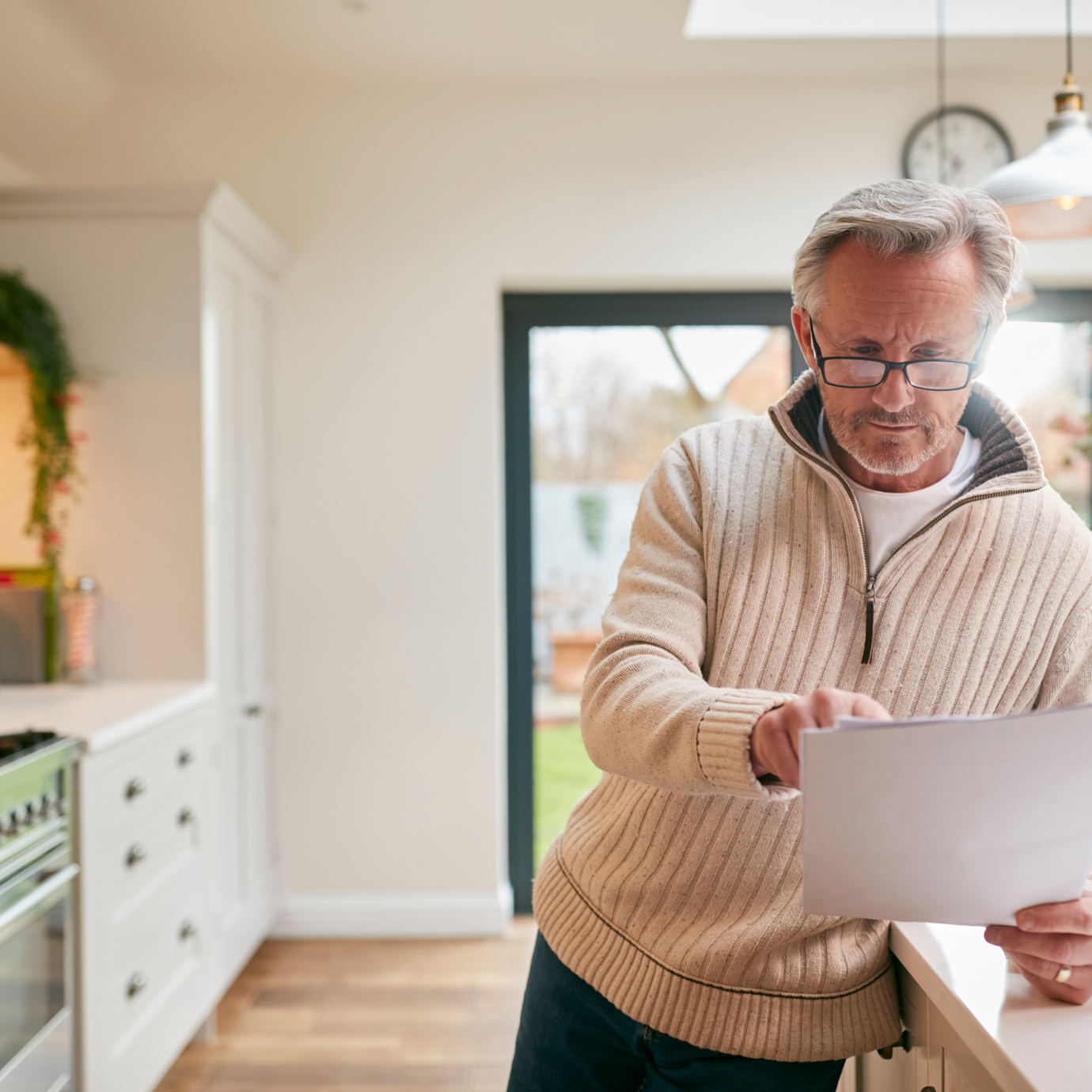 Man reviewing documents in kitchen
