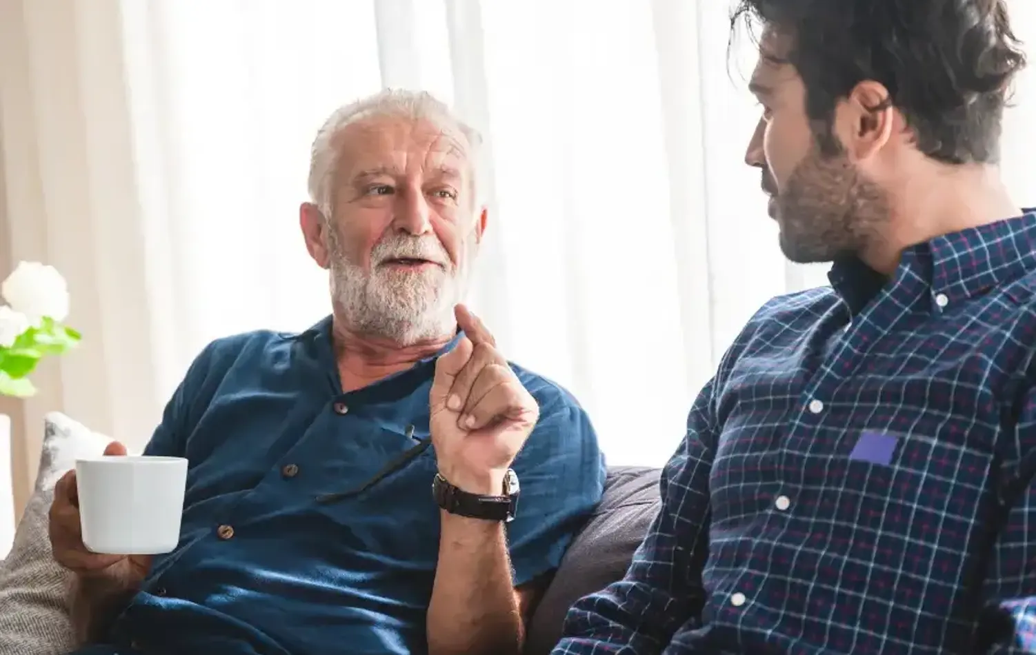 Senior man talking with a relative over a coffee