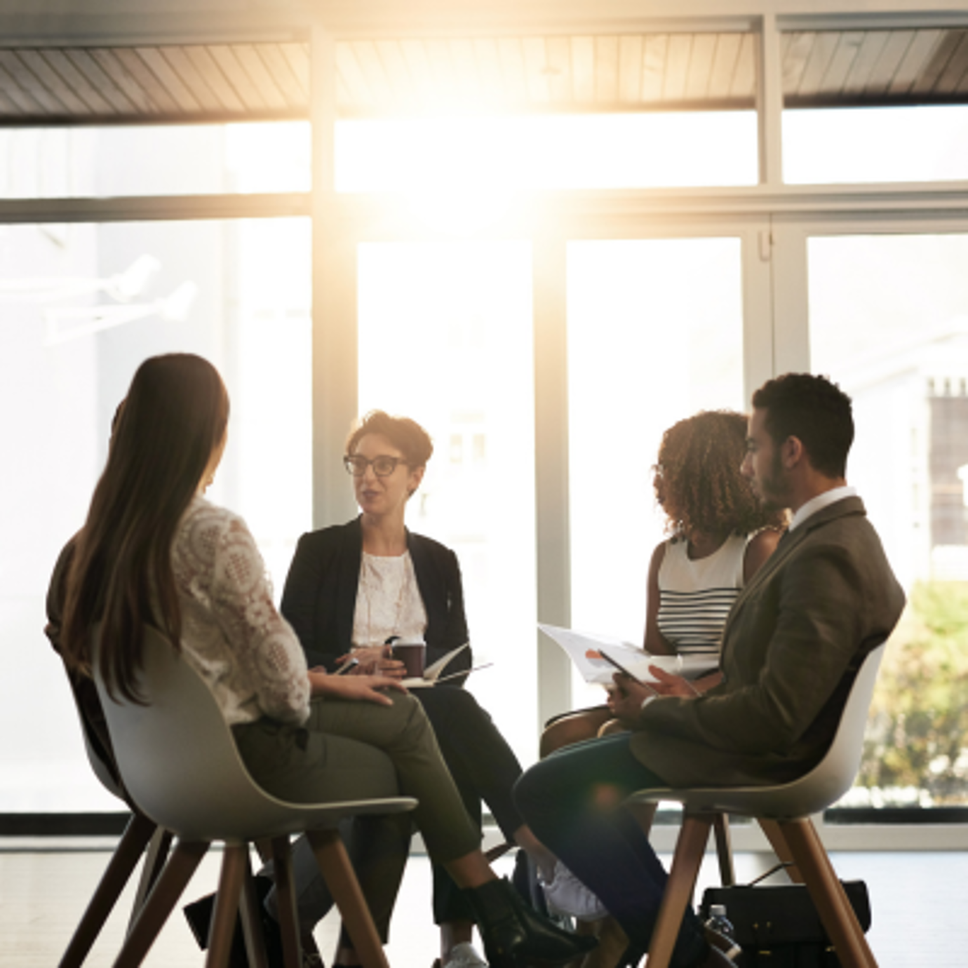 A team of workers sat in an office together having a discussion