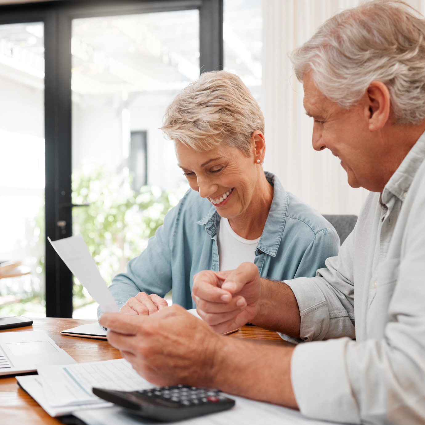 Couple reviewing pension documents happily