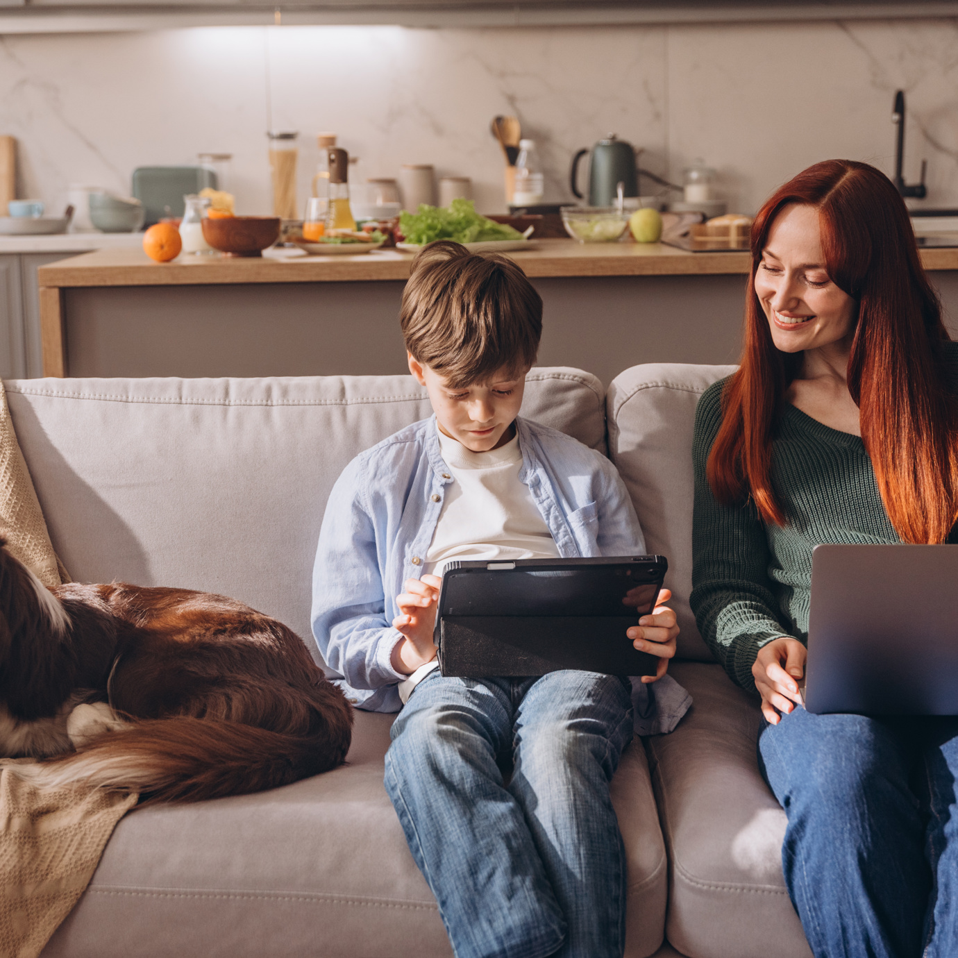 Parent and child on their laptops 