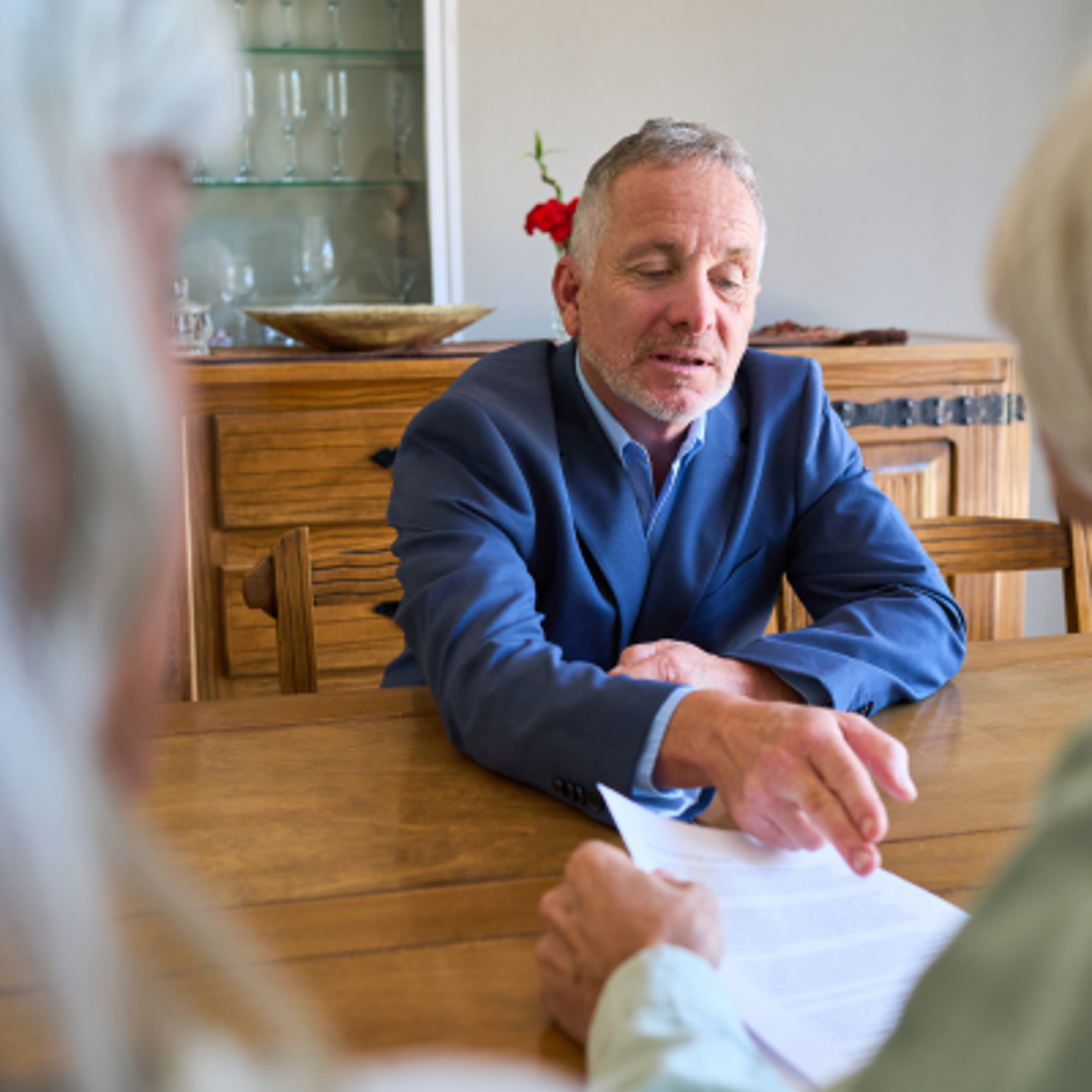 A man sat across the table from the perspective of a senior couple sat on the other side